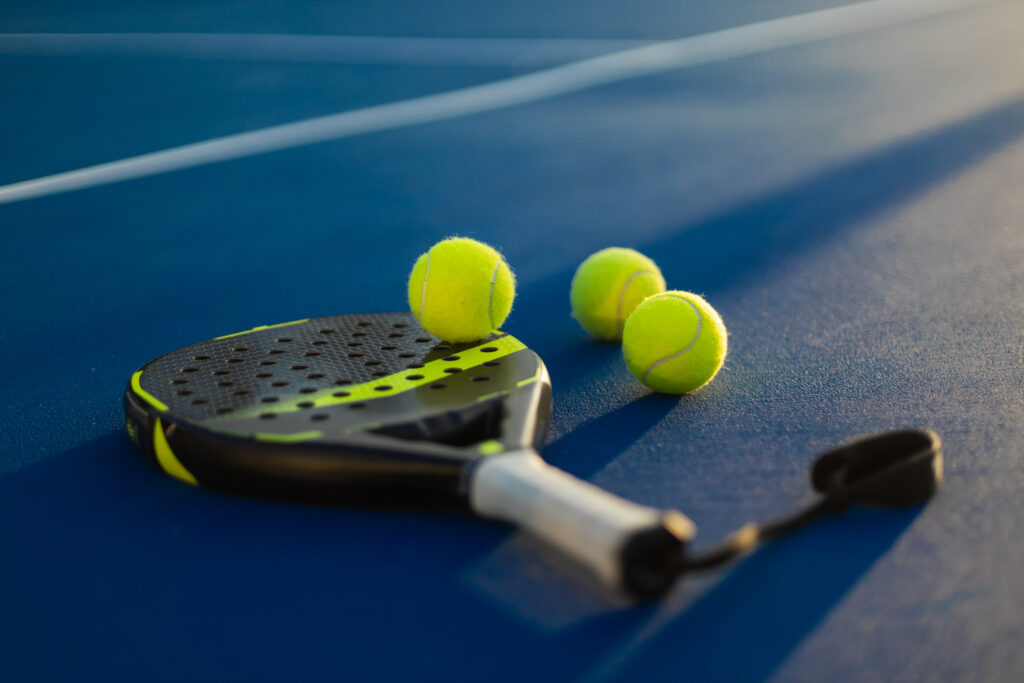 Padel tennis rackets. Sport court and balls. Download a high quality photo with paddle for the design of a sports app or social media advertisement